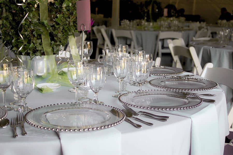 formal round table setting with white tablecloth and napkins