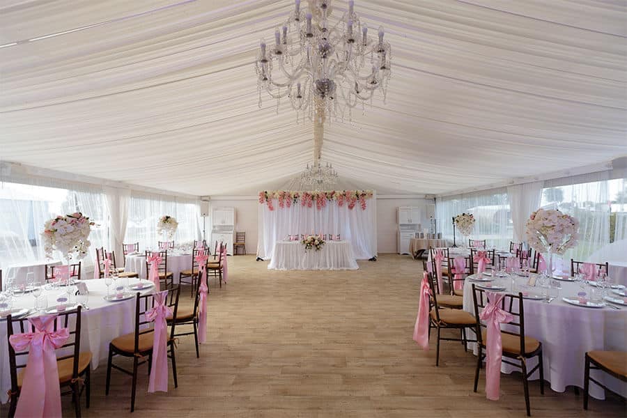 frame tent with chandelier and wooden flooring