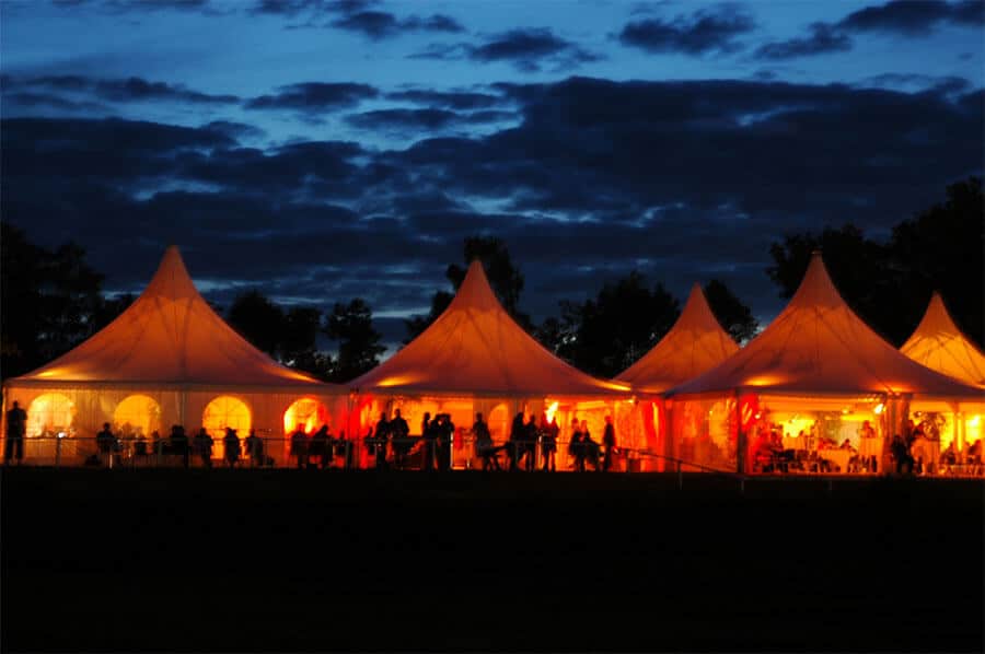 pole tents silhouette evening reception outdoor event